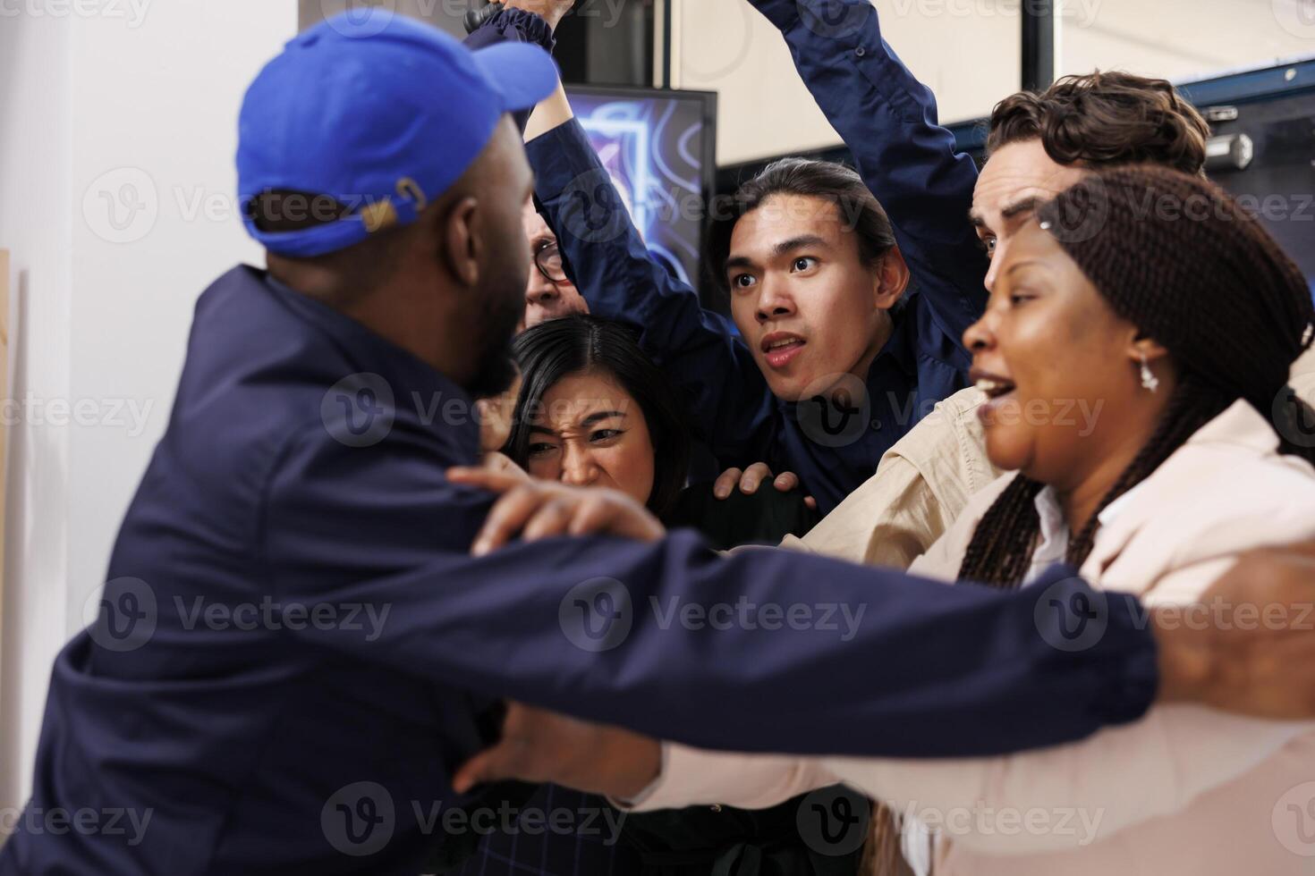 African man security guard pushing back crazy obsessed customers at shop entrance during Black Friday sale. Crowd of anxious diverse people shoppers breaking into shopping mall on Cyber Monday photo