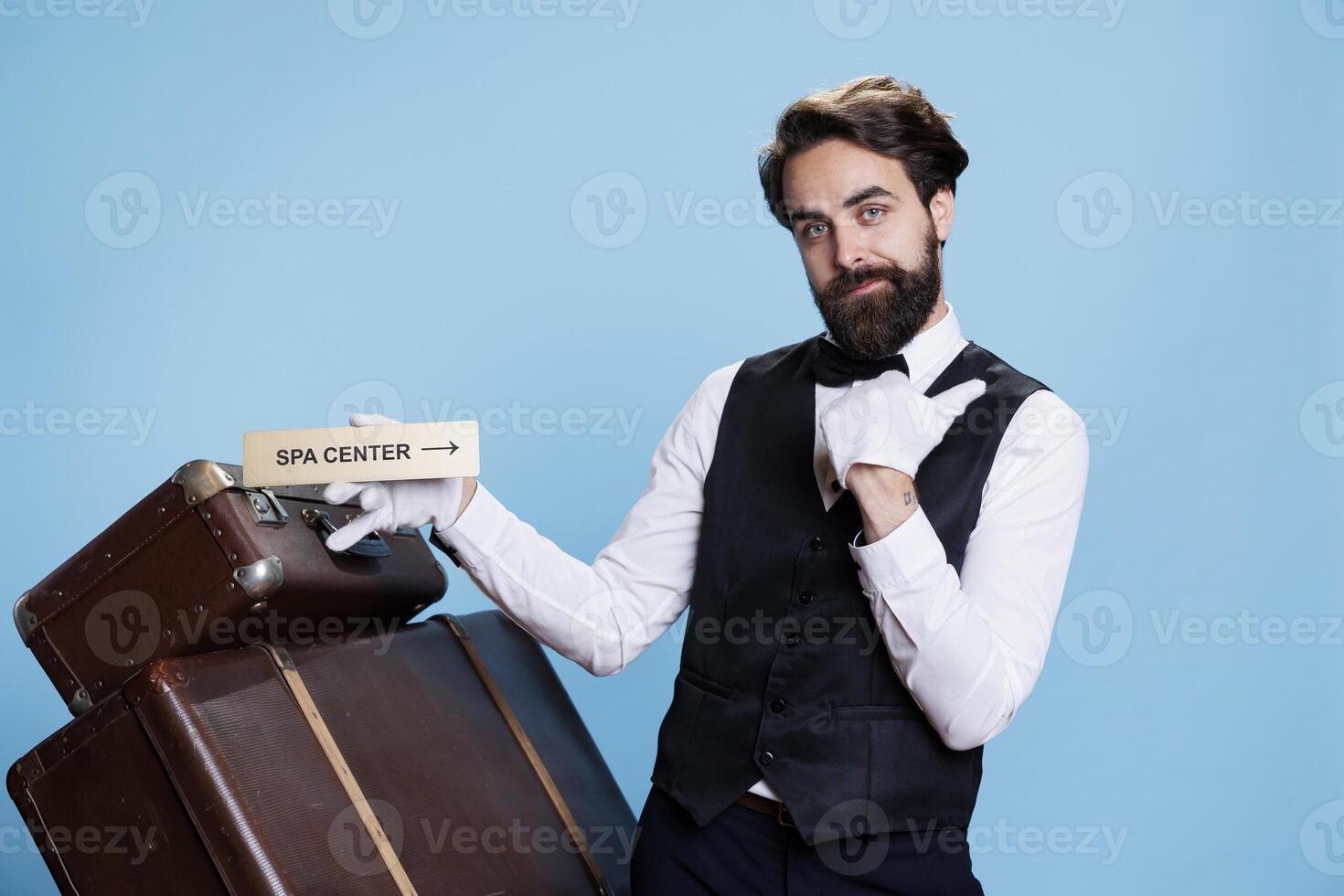 hotel empleado trabajos en viaje sector y Guías visitantes a el relajación zona utilizando indicación para el spa. elegante hombre en formal atuendo indicando y mostrando puntero con ubicaciones. foto