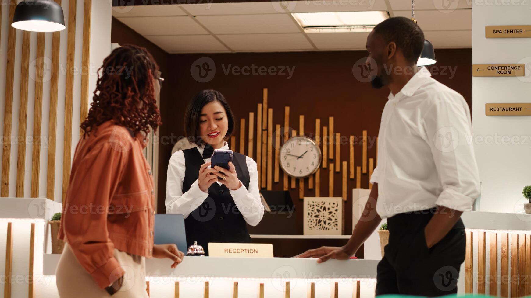 Tourists using debit card to pay during check in process in luxury hotel during honeymoon trip. Newlywed couple purchasing additional room amenities not included in holiday package photo