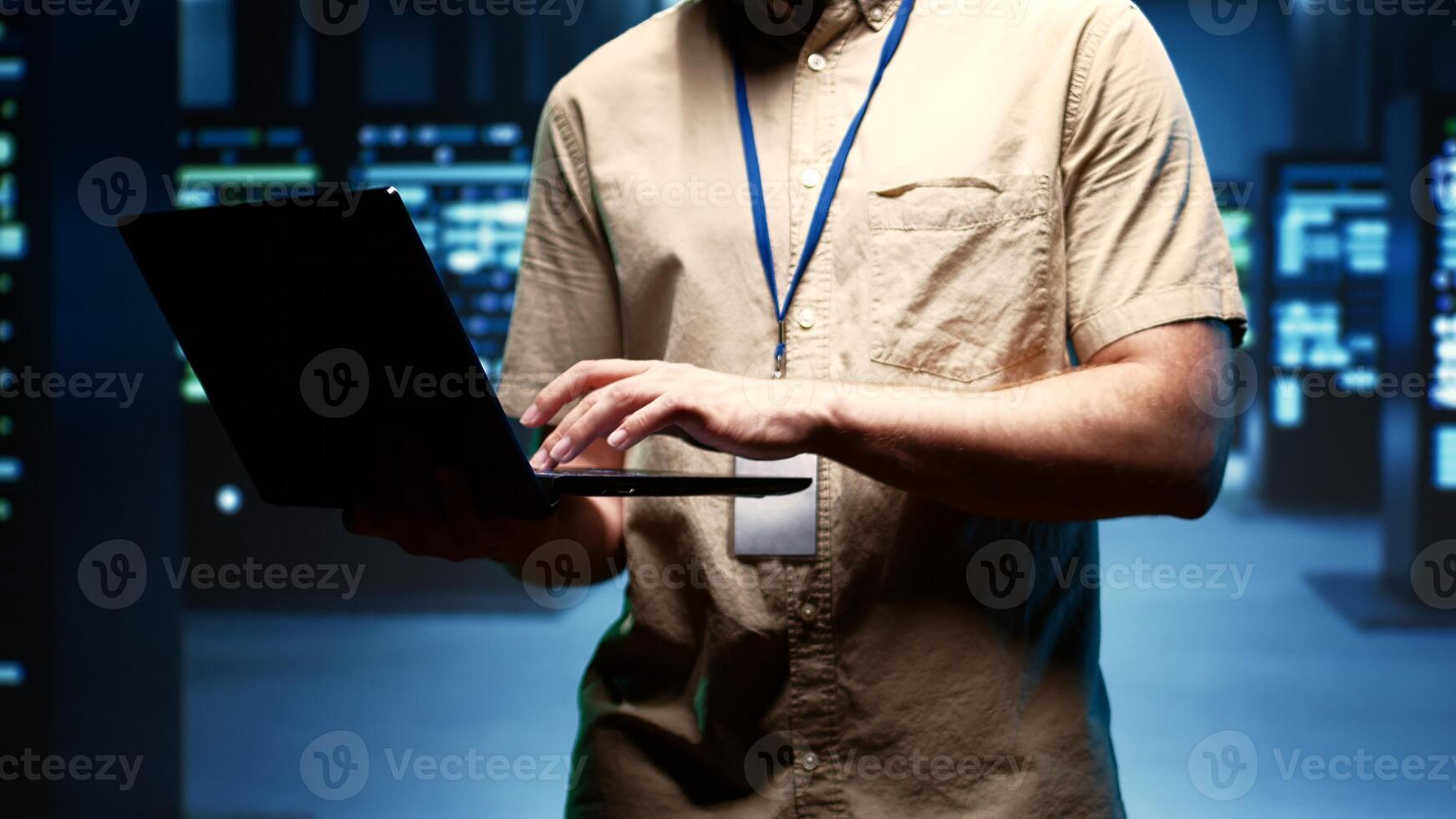 Close up of technician walking between operational server clusters in high performance computing data center, ensuring optimal operations. Admin monitoring energy consumption across systems photo