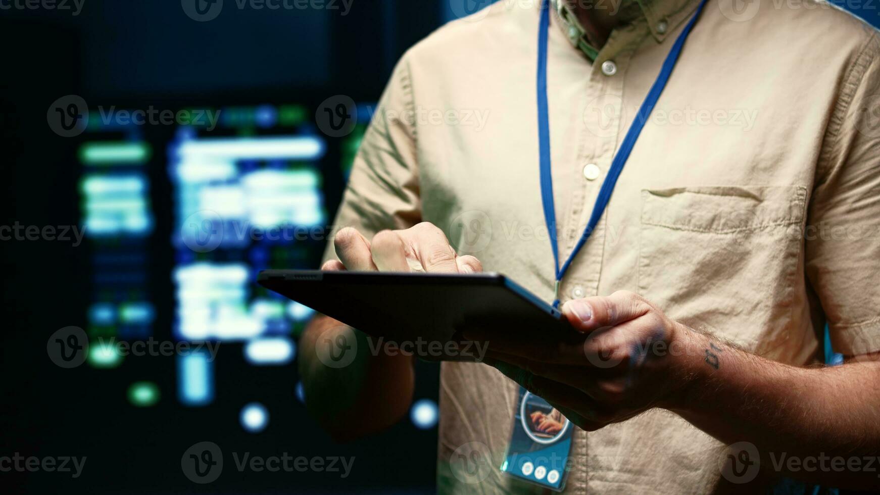 Close up shot of expert doing routine system review, adding data on tablet of needed mendings in server clusters housing advanced data storage infrastructure supporting critical IT workloads photo