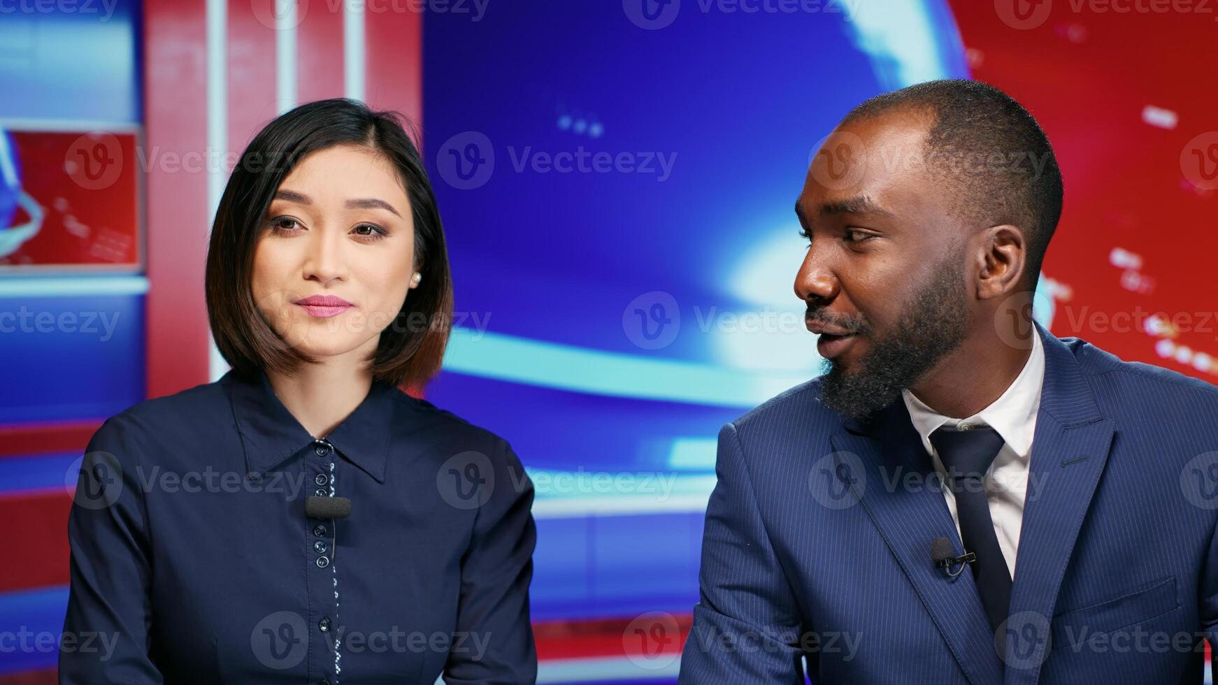 Diverse journalists host morning show on tv presenting daily events or scandals for entertainment media segment on television. Presenters team discussing breaking news topics in newsroom. photo