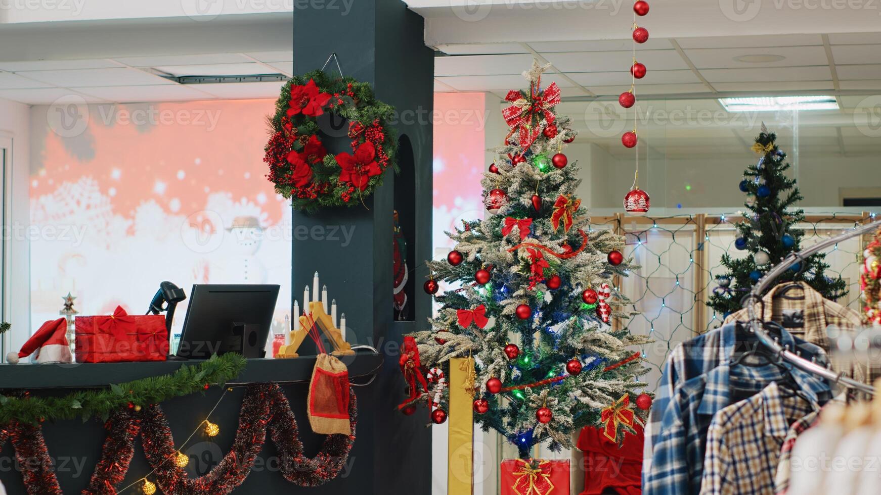 Beautifully decorated Christmas tree in clothing store ready to spread holiday cheer to visiting customers looking to buy presents. Xmas adorn fashion boutique in mall during winter holiday season photo