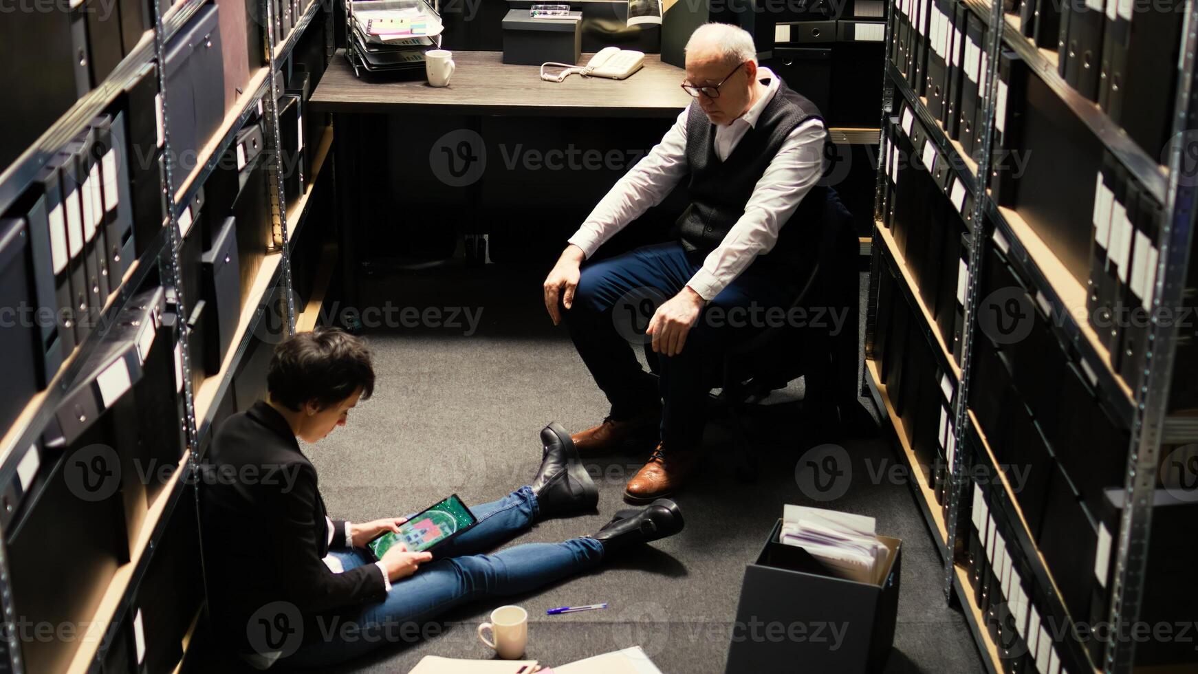 Agents team review statements and surveillance footage, using classified file records. Private detectives waiting to receive forensic evidence authenticity report, build suspect profile. photo