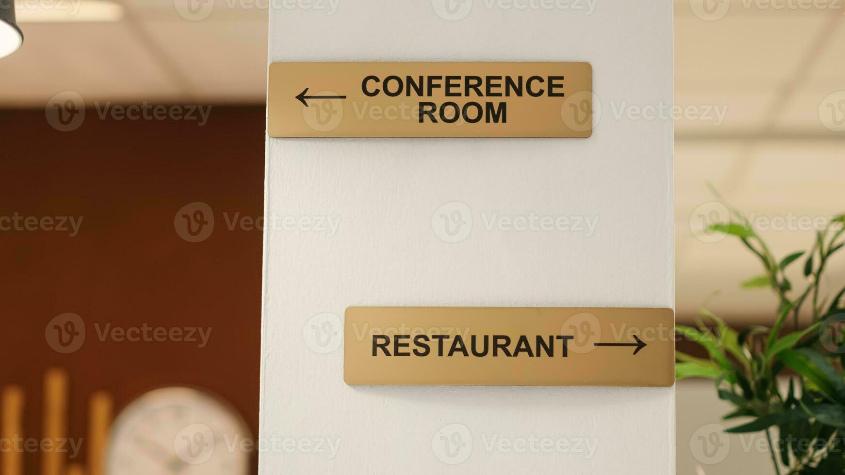 Close up of directions signs to restaurant, conference room and spa center amenities. Hotel facilities signs on travel vacation accommodation resort lounge wall, jib up shot photo
