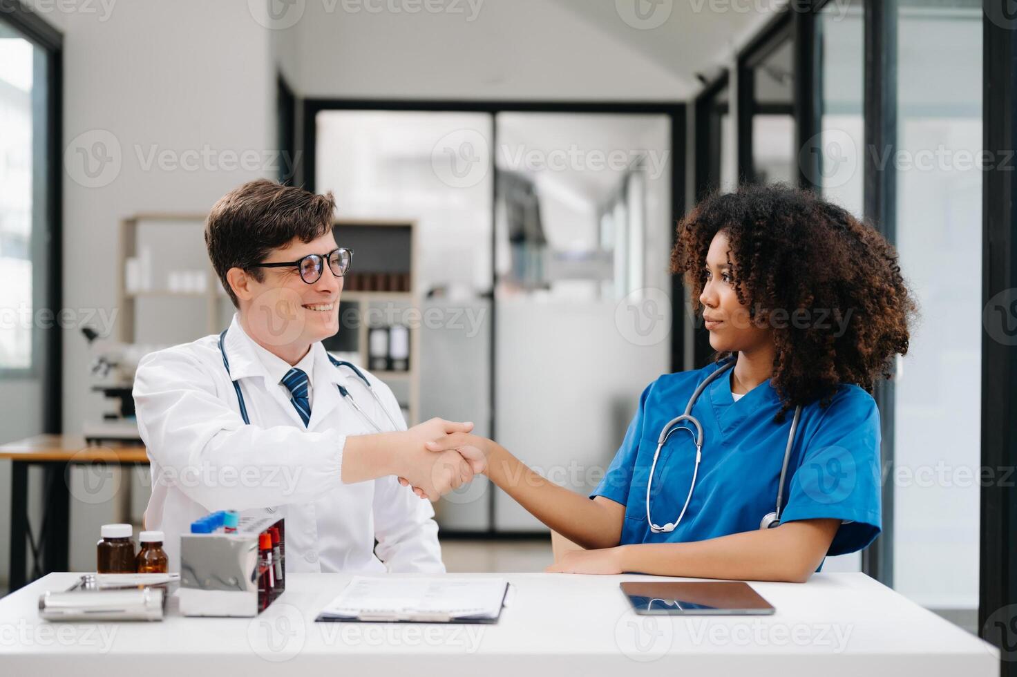 Doctor handshake and partnership in healthcare, medicine or trust for collaboration, unity or support.Team of medical experts shaking hands in teamwork for or success in clinic or hospital photo