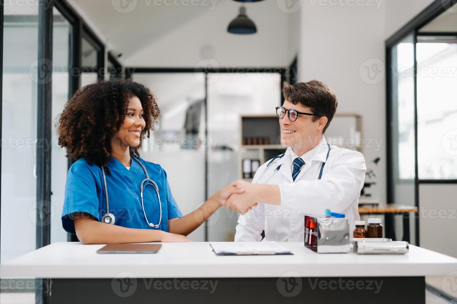 Doctor handshake and partnership in healthcare, medicine or trust for collaboration, unity or support.Team of medical experts shaking hands in teamwork for or success in clinic or hospital photo