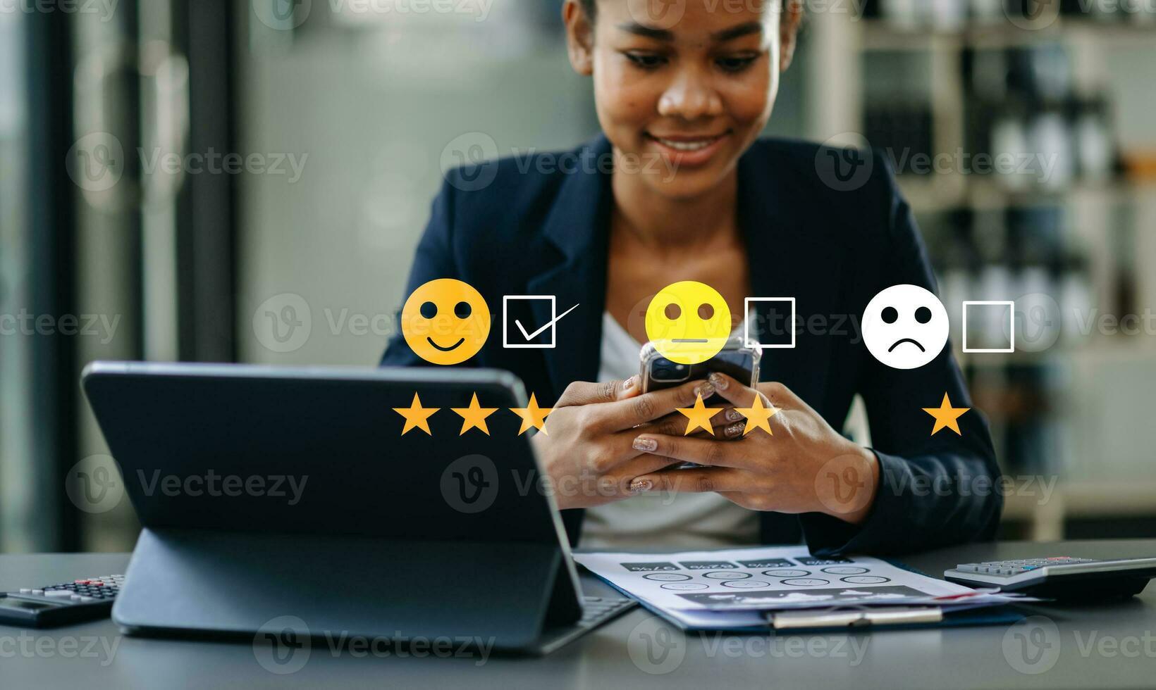 Customer service evaluation concept. Businesswoman pressing face smile emoticon show on virtual screen at tablet and smartphone in office photo