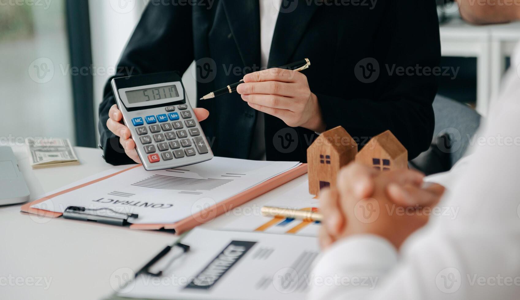 Signing a contract. Client and broker agent, lease agreement, successful deal and  Young business sitting at the desk in office photo