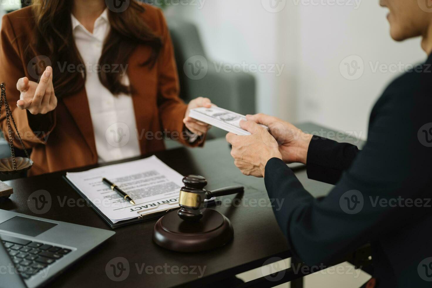 justice and law concept.passing bribe money in the envelop at office. businessman hand taking bribe money from female photo