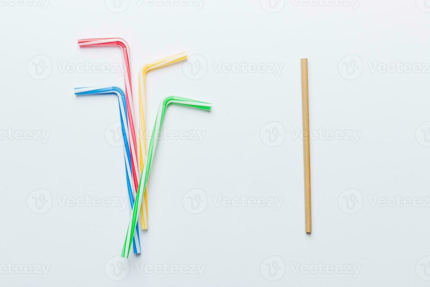 Drinking straws for party on Colored background. Top view of colorful plastic disposable straws for summer cocktails. different straws for juice with copy space photo