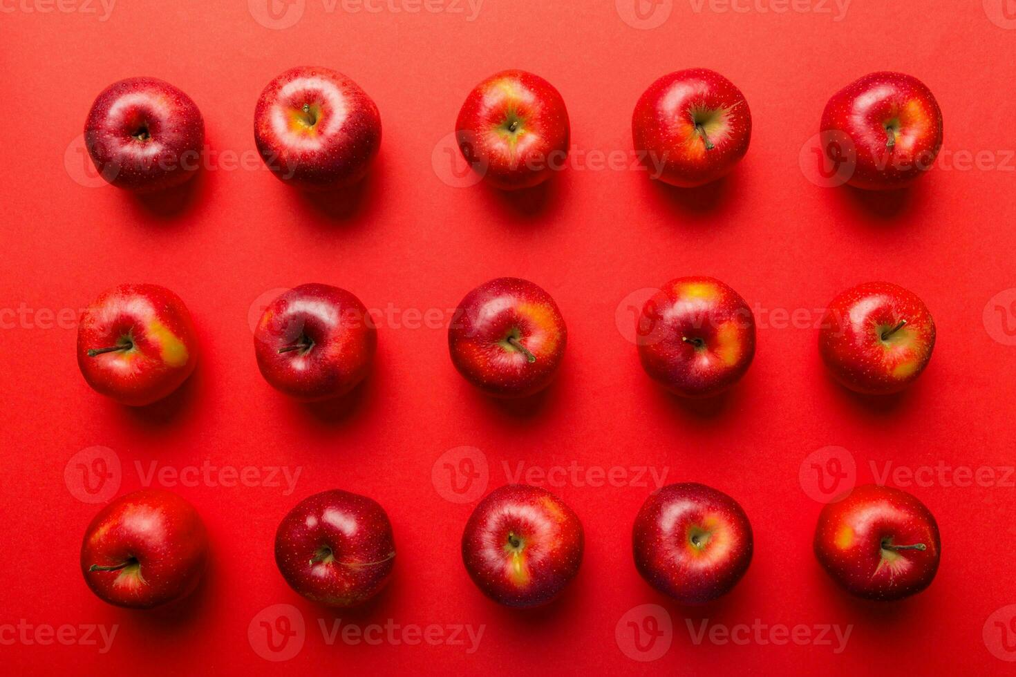 Many red apples on colored background, top view. Autumn pattern with fresh apple above view photo