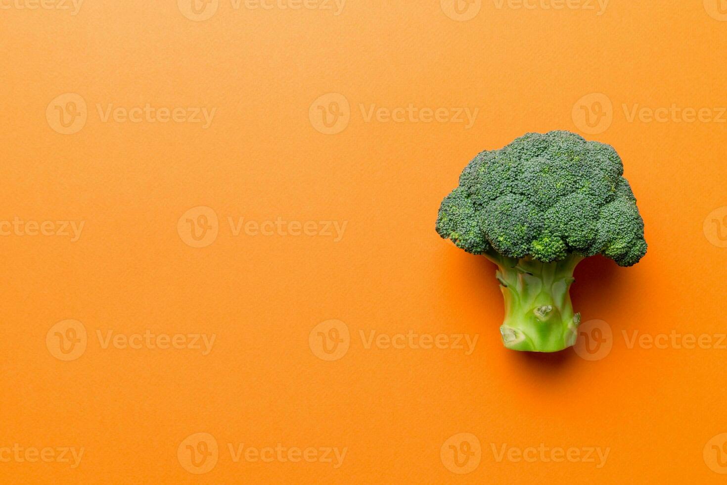 Top view fresh green broccoli vegetable on Colored background. Broccoli cabbage head Healthy or vegetarian food concept. Flat lay. Copy space photo
