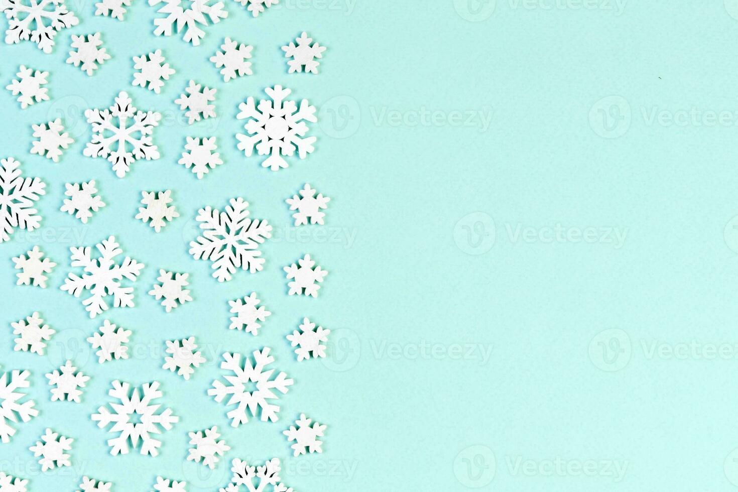 Top view of white snowflakes on colorful background. Winter weather concept with copy space. Merry Christmas concept photo
