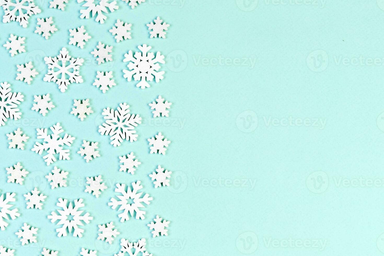 Top view of white snowflakes on colorful background. Winter weather concept with copy space. Merry Christmas concept photo