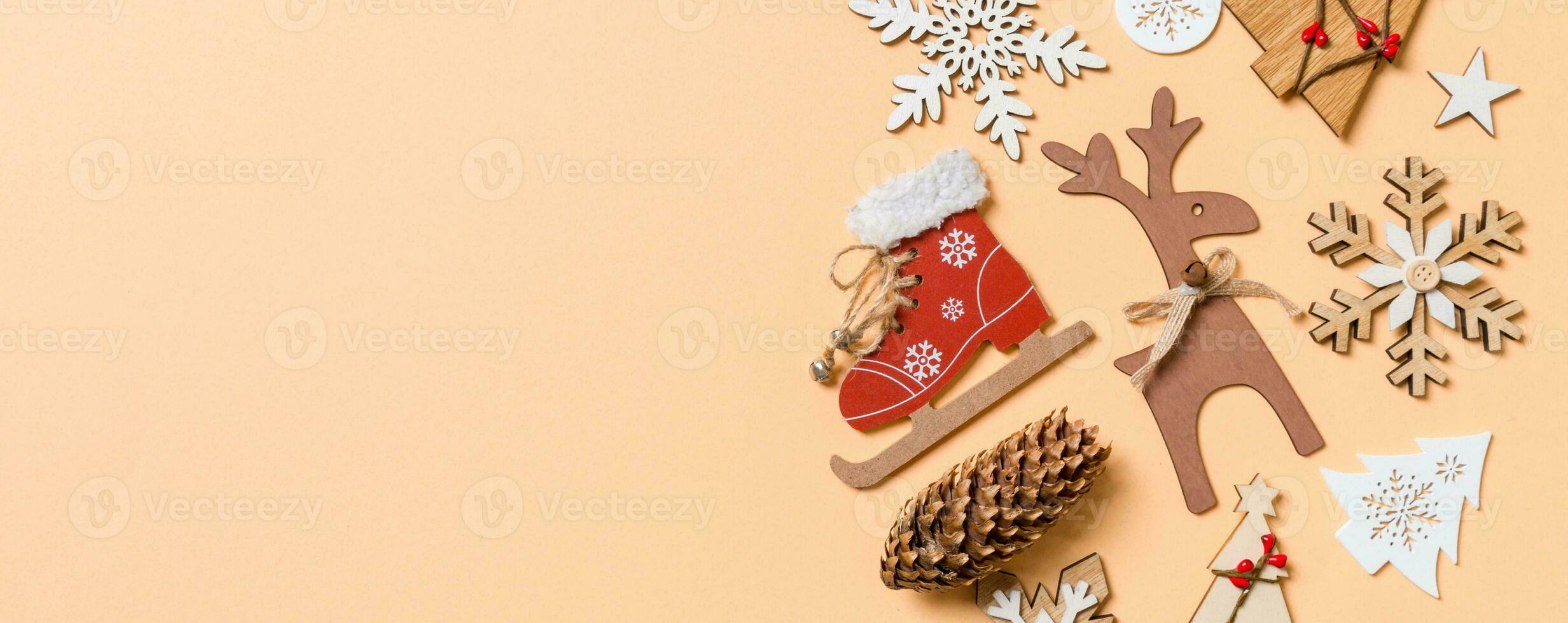 Top view of New Year toys and decorations on orange background. Christmas time concept Banner with empty space for your design photo