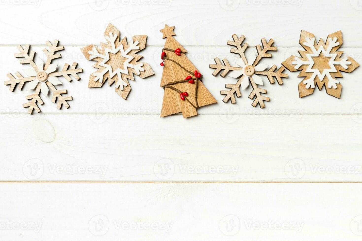 Top view of Christmas decorations and toys on wooden background. New Year holiday concept with empty space for your design photo