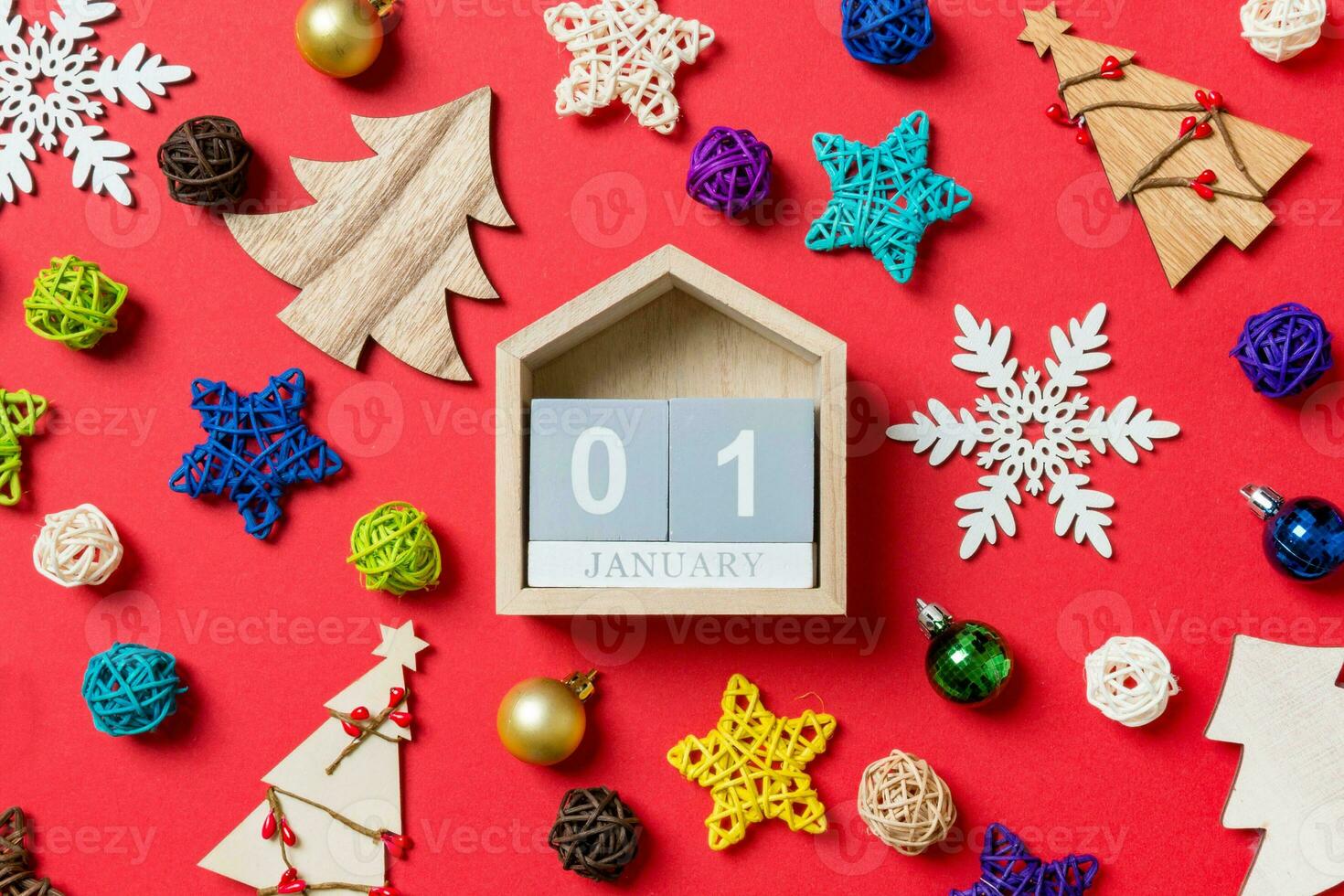 Top view of calendar on red background made of holiday decorations and toys. Christmas ornament concept photo