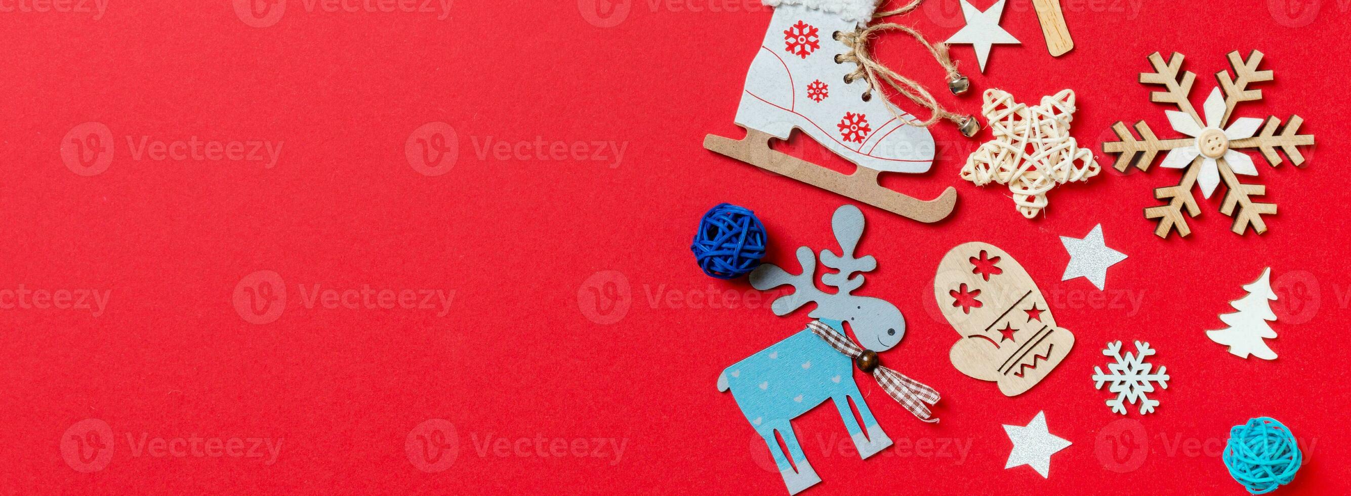 Top view Banner of holiday toys and decorations on red Christmas background. New Year time concept with copy space photo