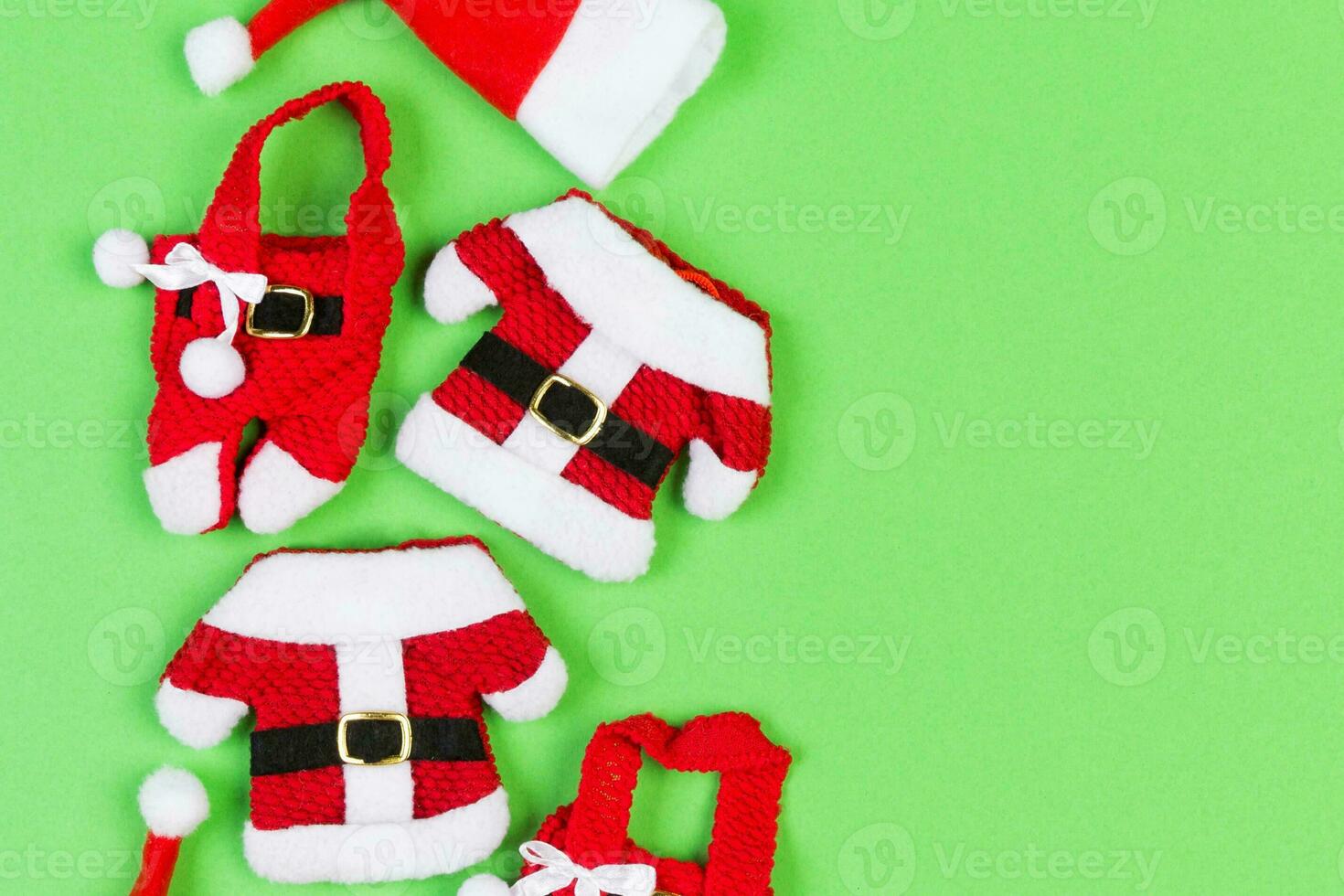Top view od stylish red Santa hats on colorful background. Merry Christmas concept with copy space photo