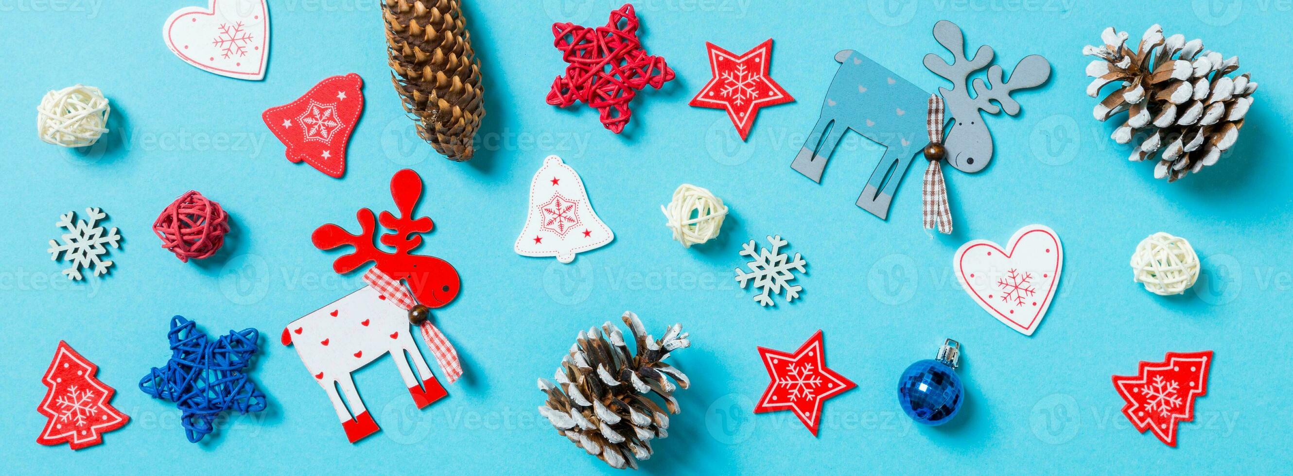 Top view of New Year toys and decorations on blue background. Banner Christmas time concept photo