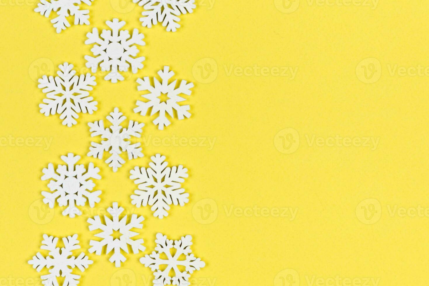 Top view of white snowflakes on colorful background. Winter weather concept with copy space. Merry Christmas concept photo