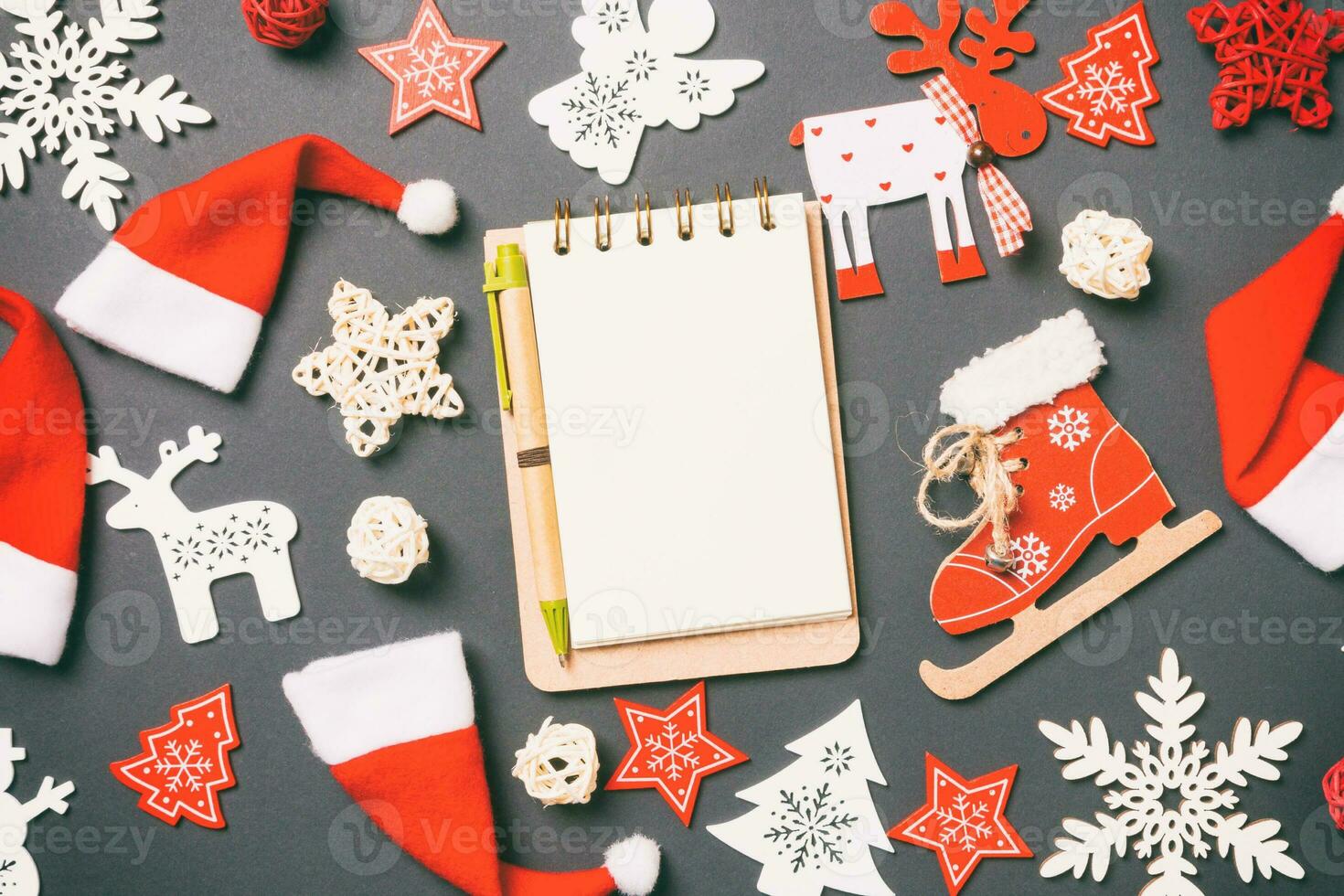 Top view of notebook. New Year decorations on black background. Merry Christmas concept photo