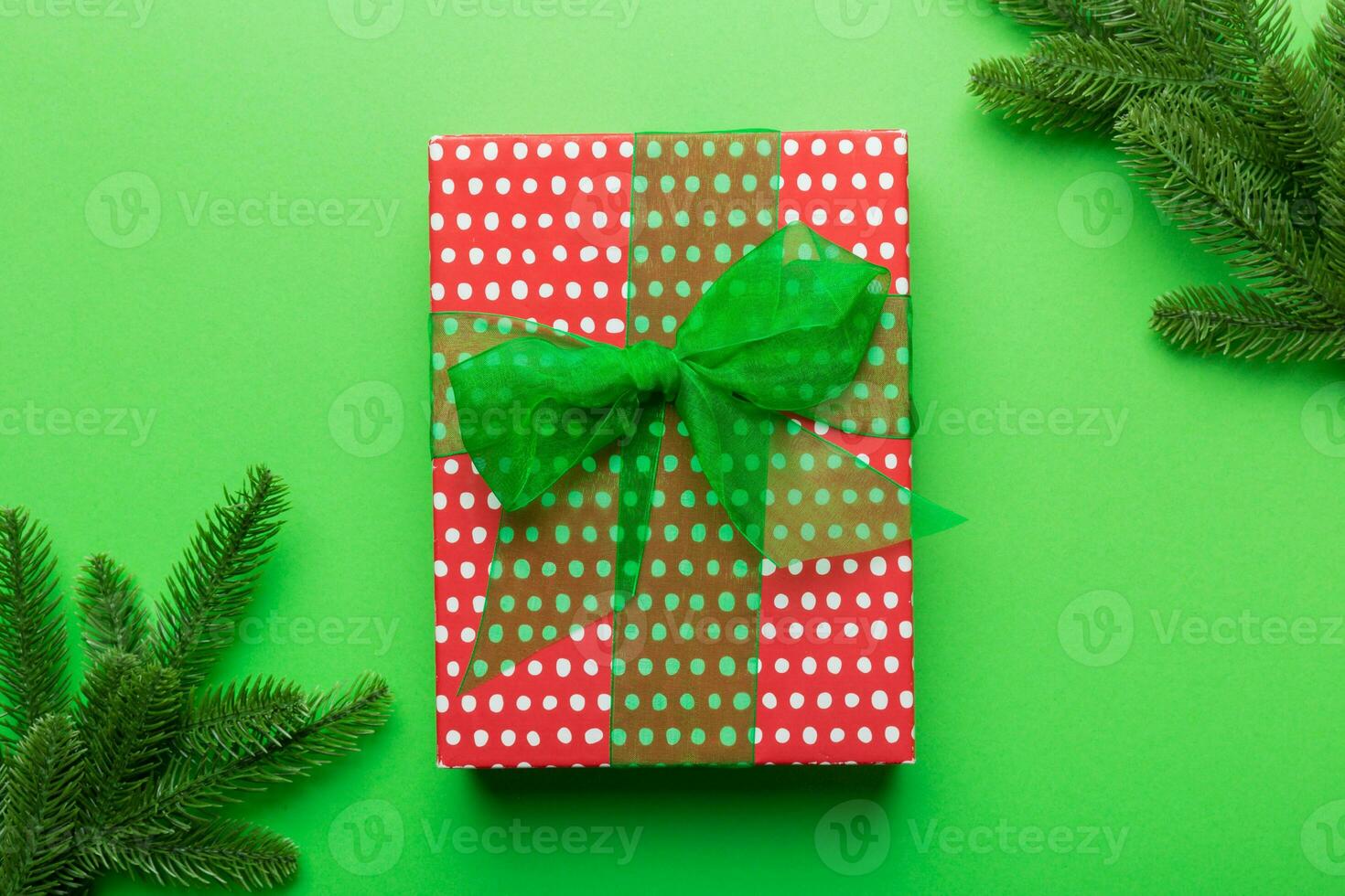 Christmas composition. Christmas gift and fir branches on cement background. Flat lay, top view, copy space photo