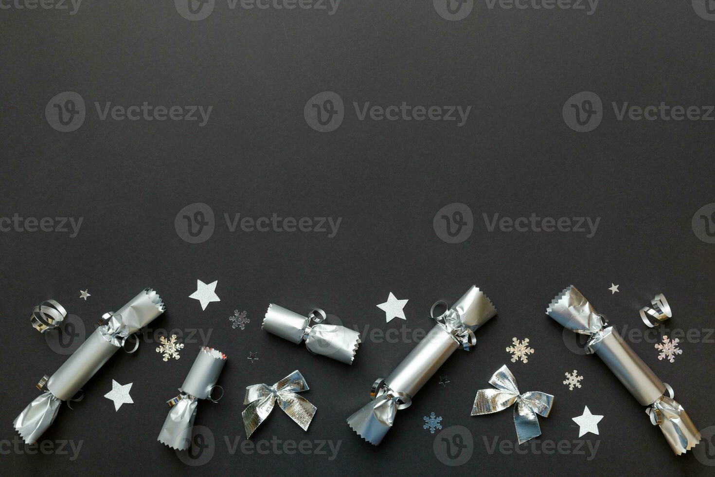 Christmas crackers with shiny confetti on color background, top view, copy space photo