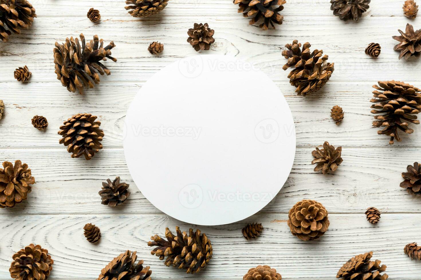 Creative frame made of Christmas pine cones with square Paper blank. Xmas and New Year theme. Flat lay, top view copy space photo