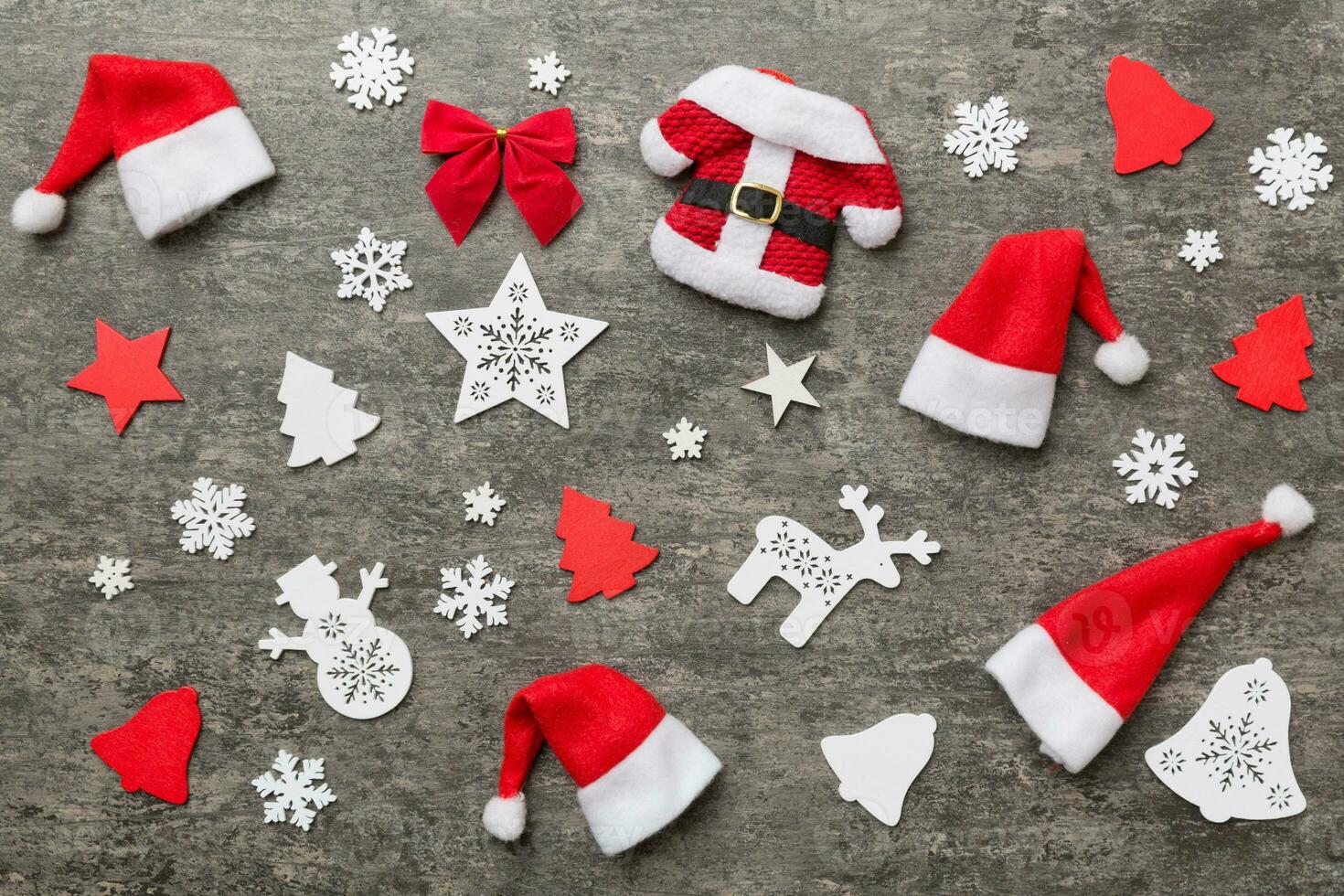 Christmas composition. Christmas hat pants Santa fur coat on color background. Flat lay, top view, copy space. Xmas postcard template photo
