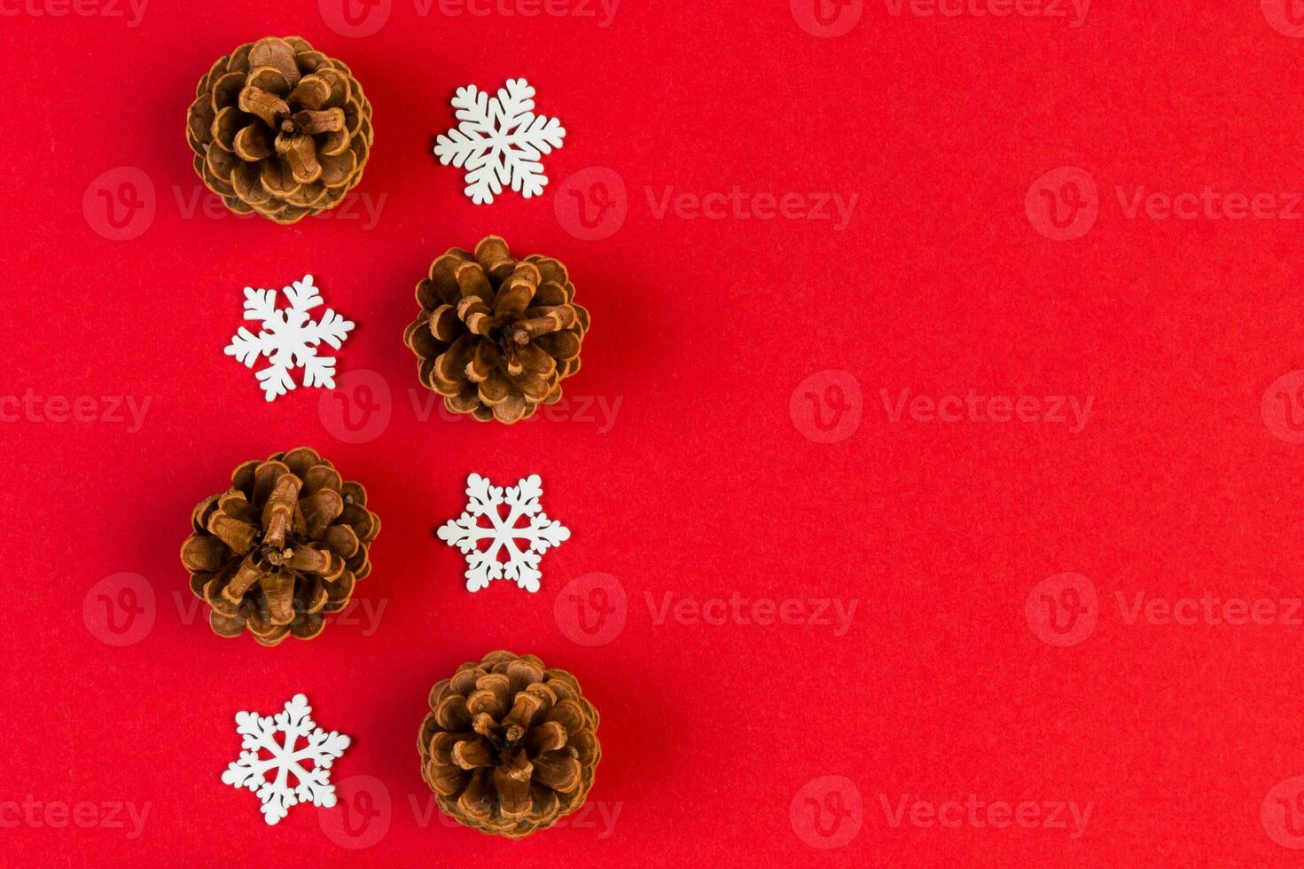 Top view of holiday composition made of pine cones and white snowflakes on colorful background. Winter time and Christmas concept with copy space photo
