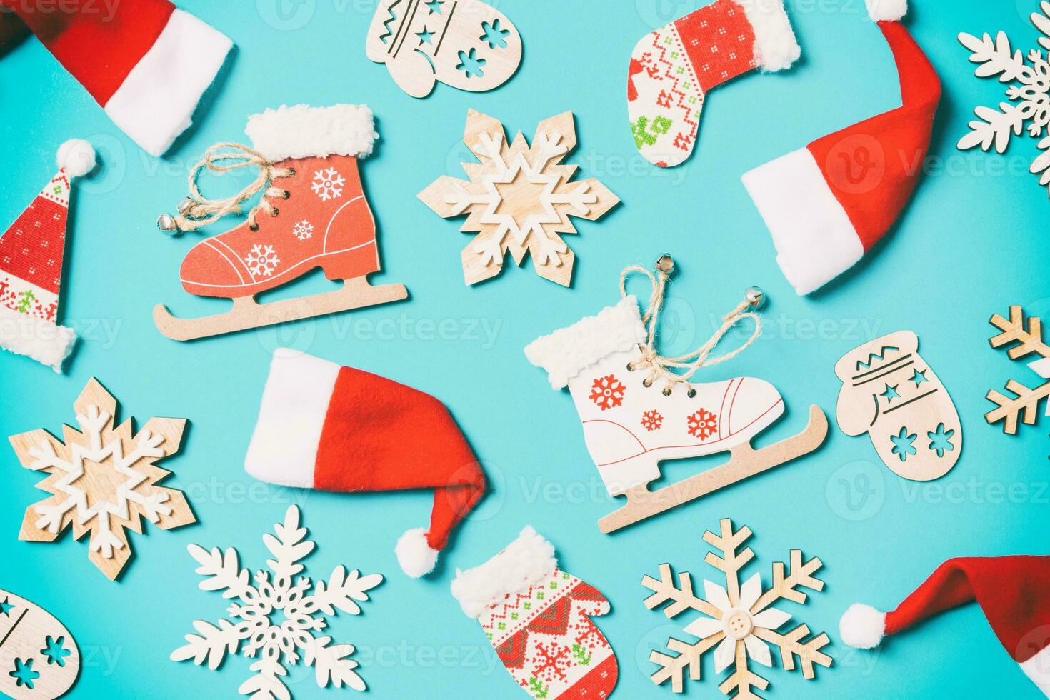 Top view of Christmas decorations and Santa hats on blue background. Happy holiday concept photo