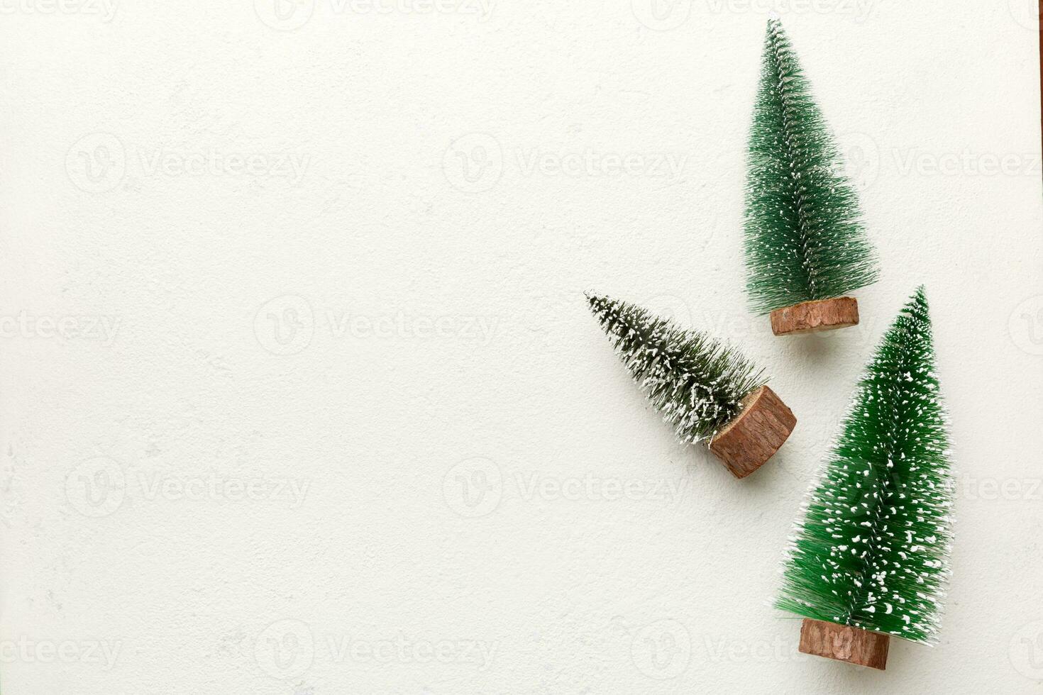 Flat lay composition with christmas trees on color background. Top view with copy space photo