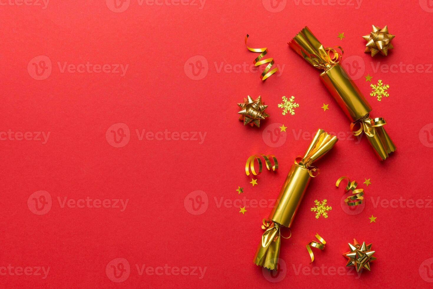Christmas crackers with shiny confetti on color background, top view, copy space photo
