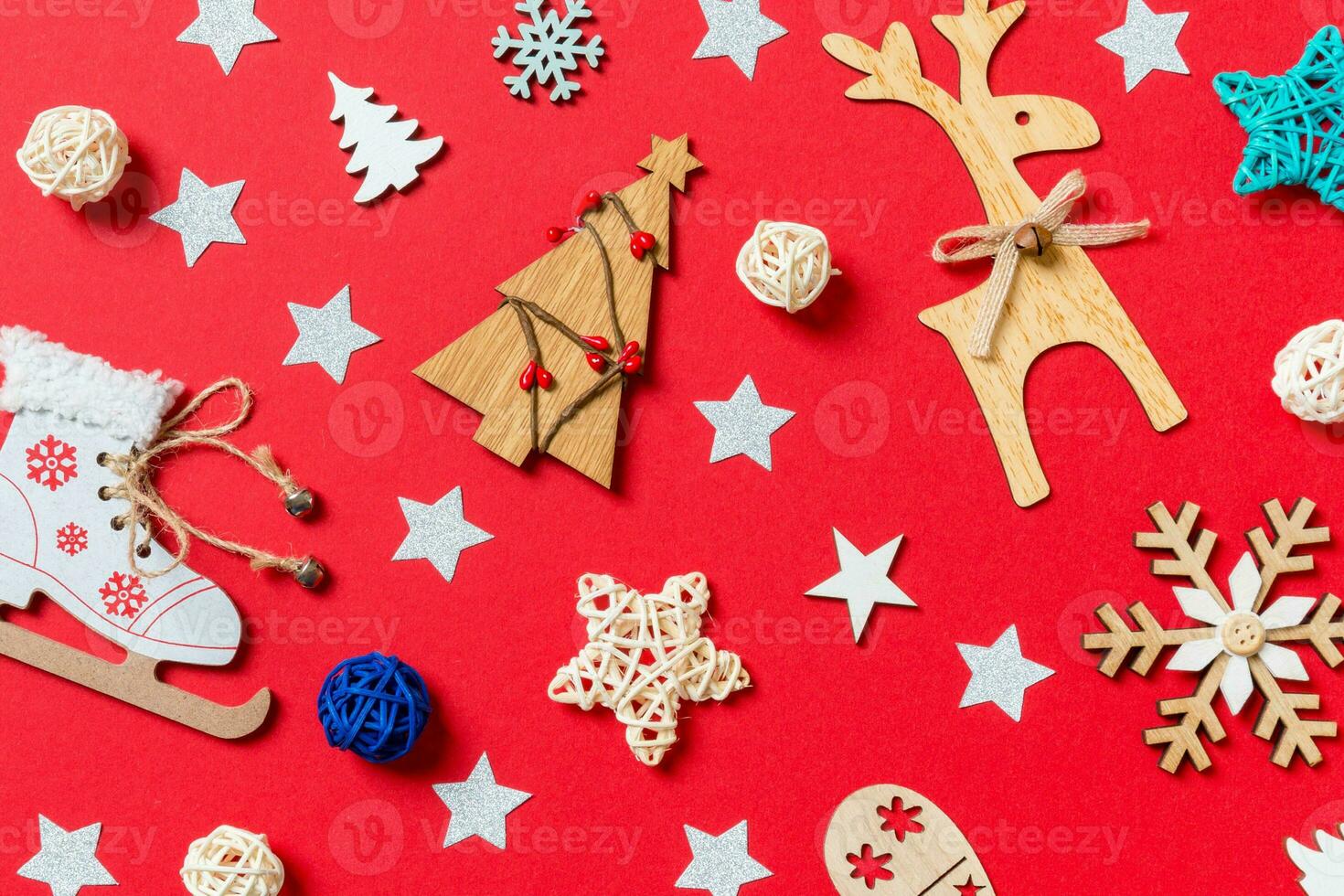 Top view of holiday toys and decorations on red Christmas background. New Year time concept photo