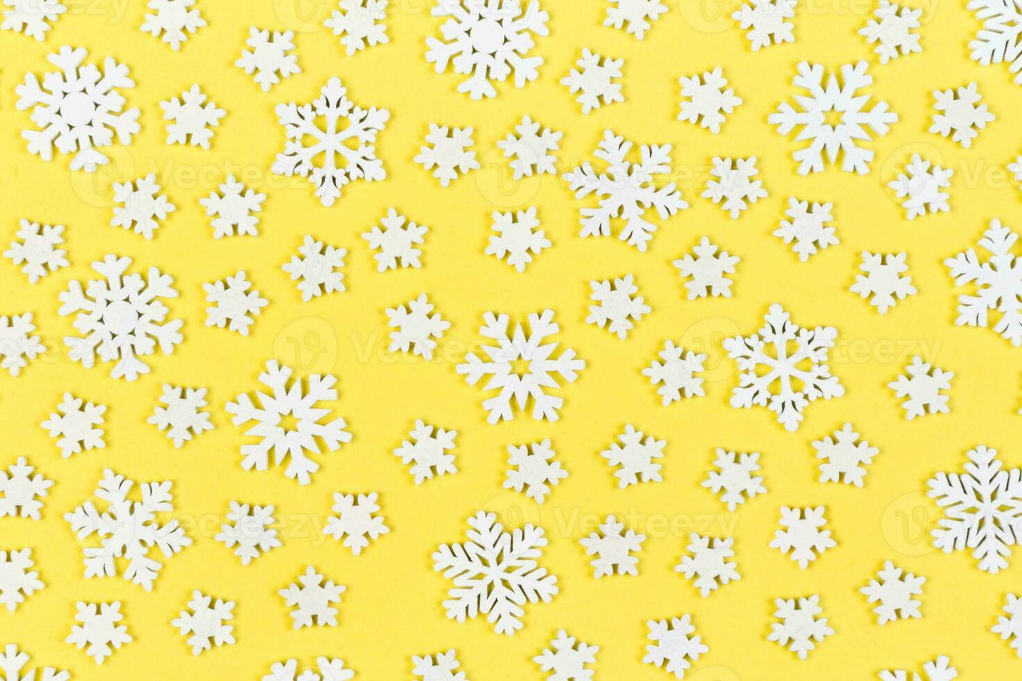 Top view of white snowflakes on colorful background. Winter weather concept with copy space. Merry Christmas concept photo
