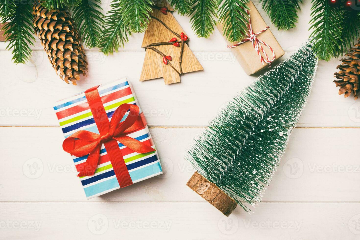 Top view of fir tree, New Year decorations, Christmas tree and present on wooden background. Time for holiday concept photo