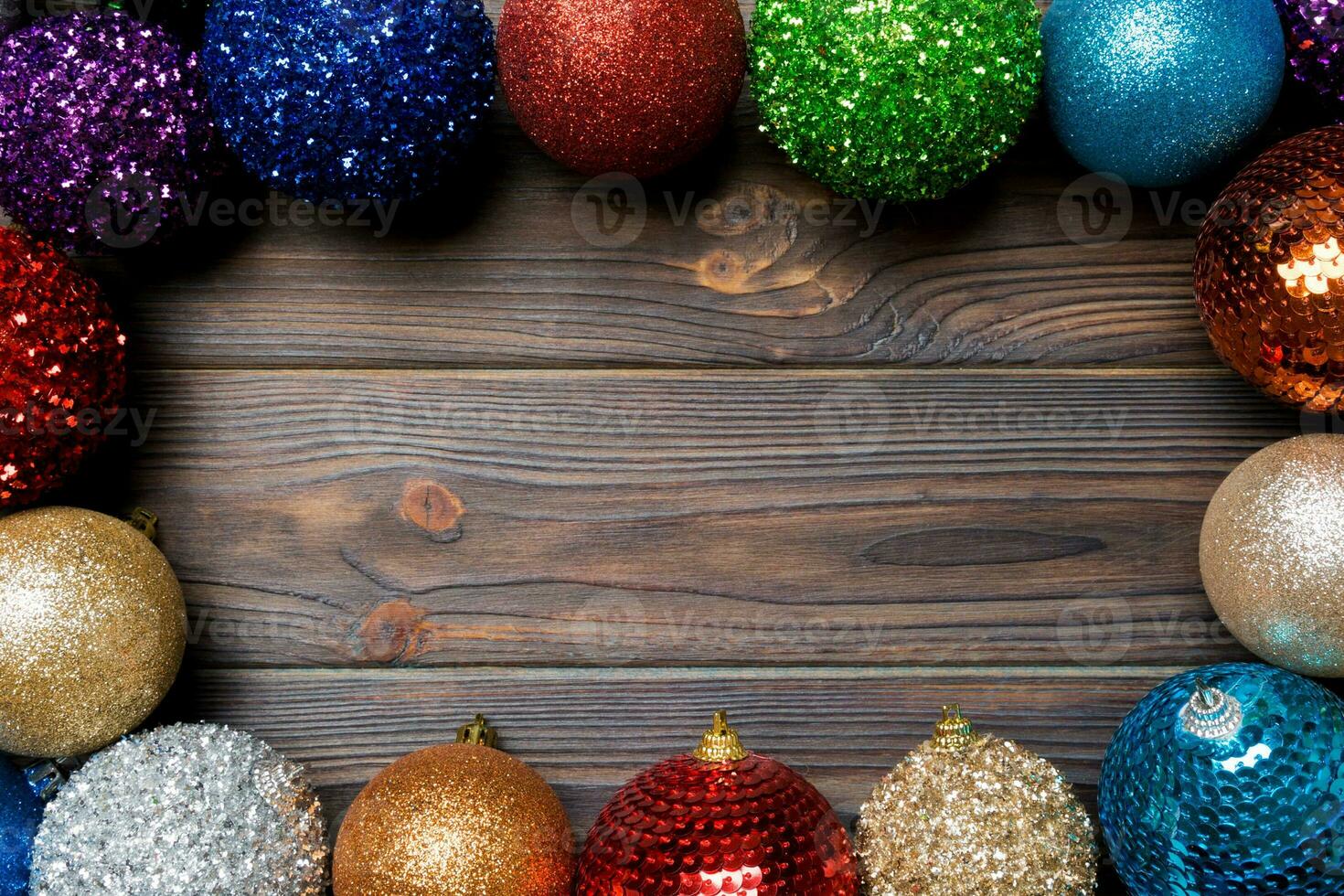 Festive composition of decorative baubles on wooden background. Top view of Christmas toys with copy space photo