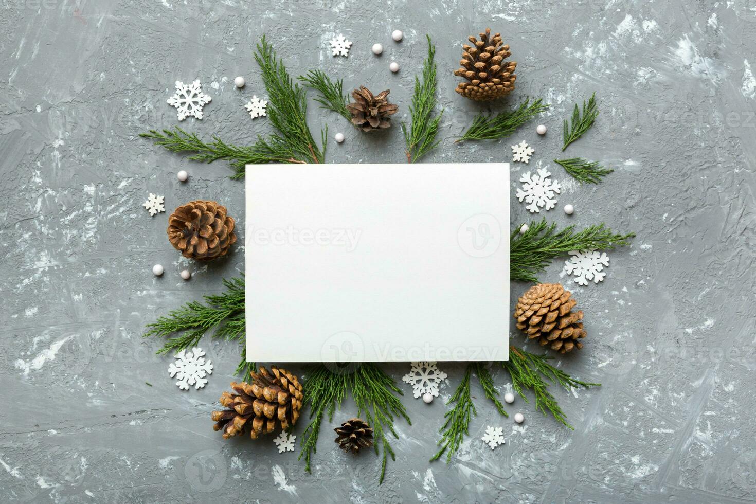 Flat lay Christmas composition. square Paper blank, pine tree branches, christmas decorations on Colored background. Top view, copy space for text photo
