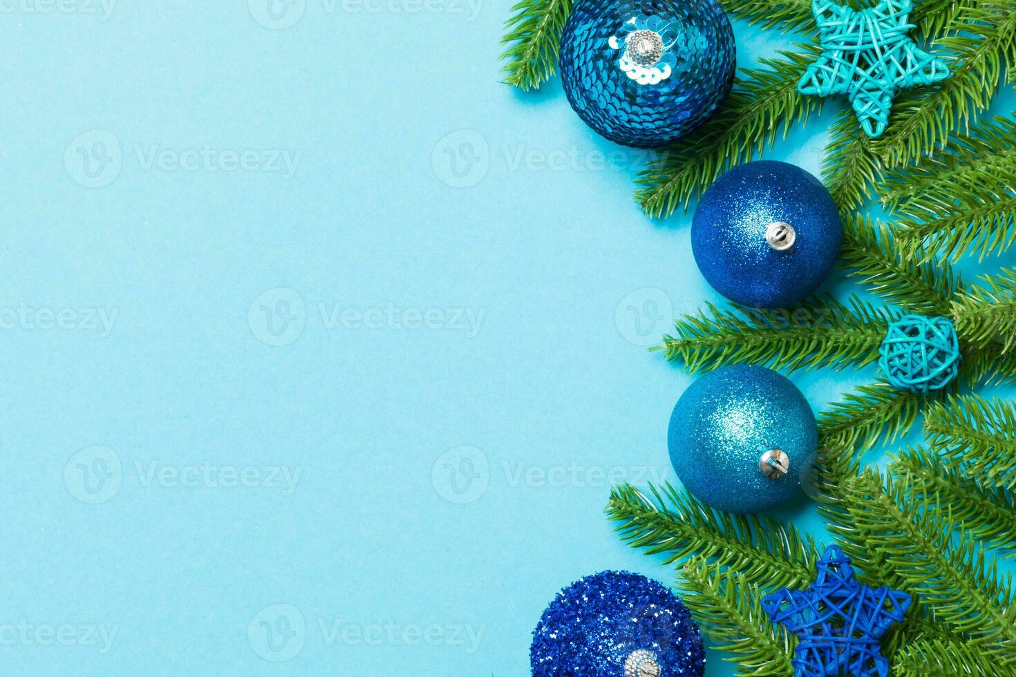Set of festive balls, fir tree and Christmas decorations on colorful background. Top view of New Year ornament concept with copy space photo