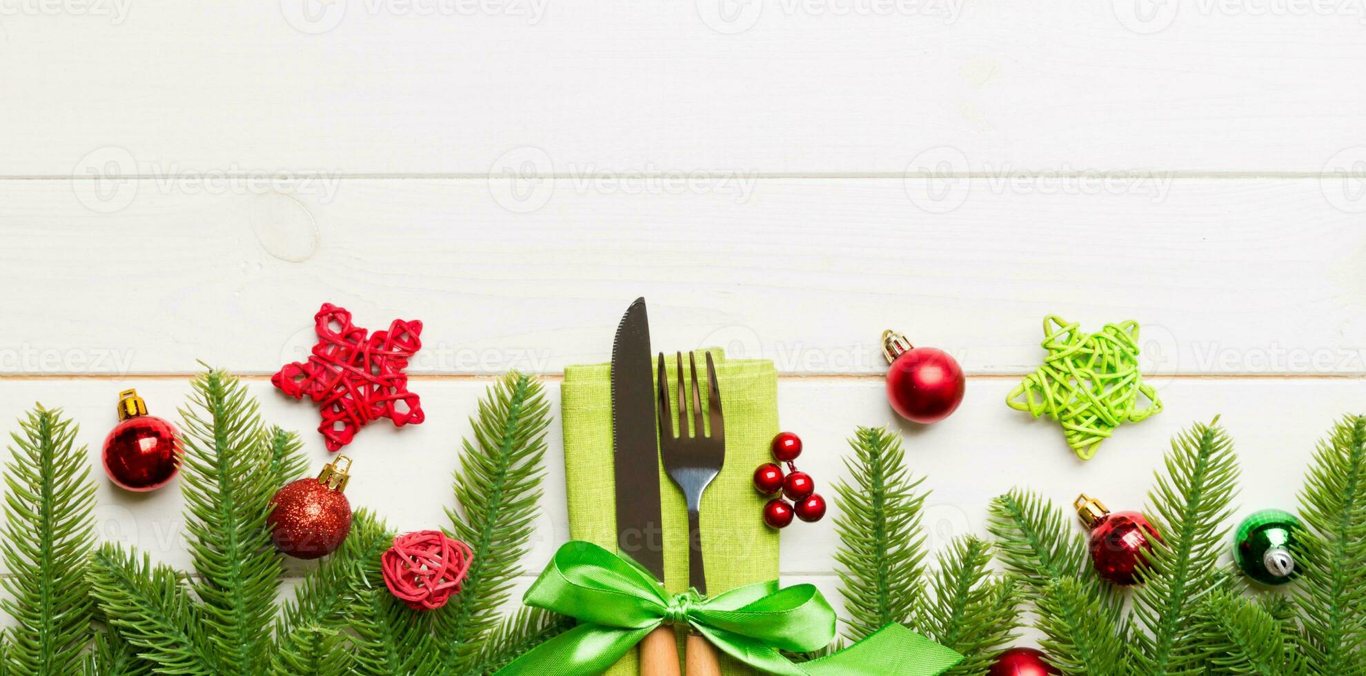 Top view Banner of festive cutlery on new year wooden background. Christmas decorations with empty space for your design. Holiday dinner concept photo