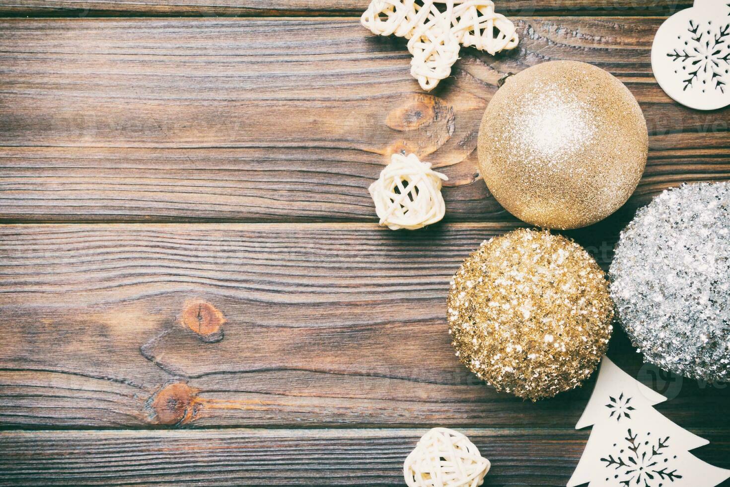 Top view of festive winter composition on wooden background with empty space for your design. Christmas baubles and decorations. New Year concept photo