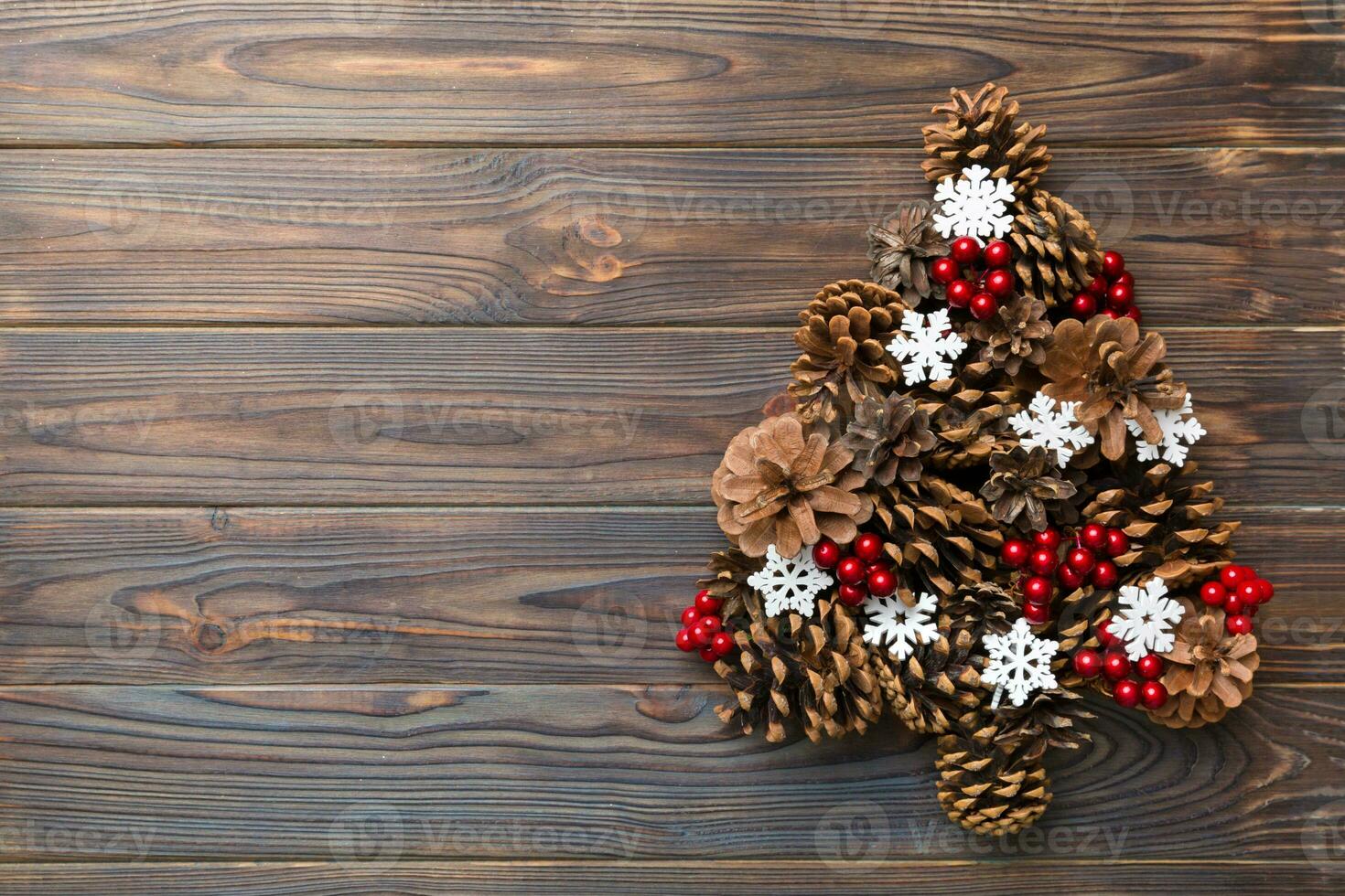 Christmas tree made from natural cones on colored background, view from above. New Year minimal concept with copy space photo