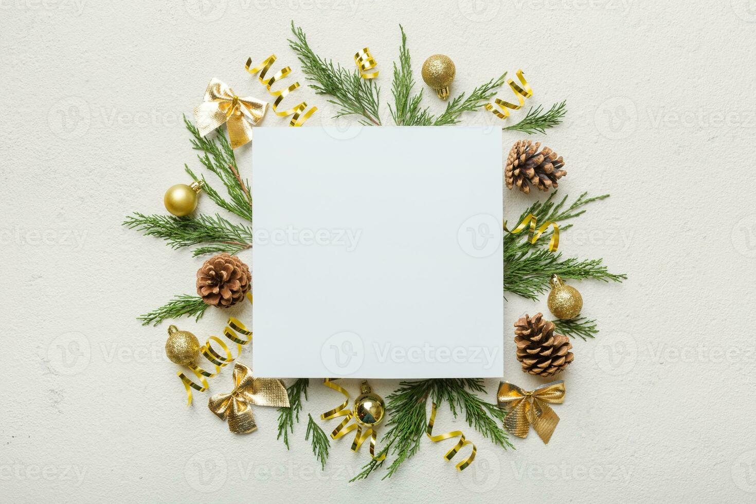 Flat lay Christmas composition. square Paper blank, pine tree branches, christmas decorations on Colored background. Top view, copy space for text photo