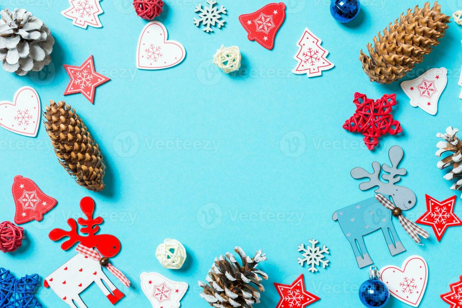 Top view of New Year toys and decorations on blue background. Christmas time concept with empty space for your design photo