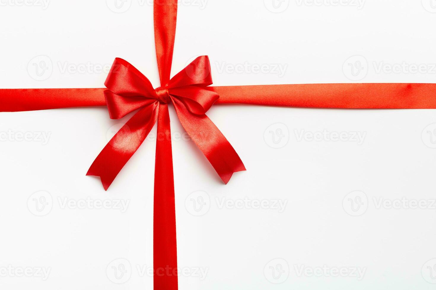 Top view of Red ribbon rolled and red bow isolated on colored background. Flat lay with copy space photo