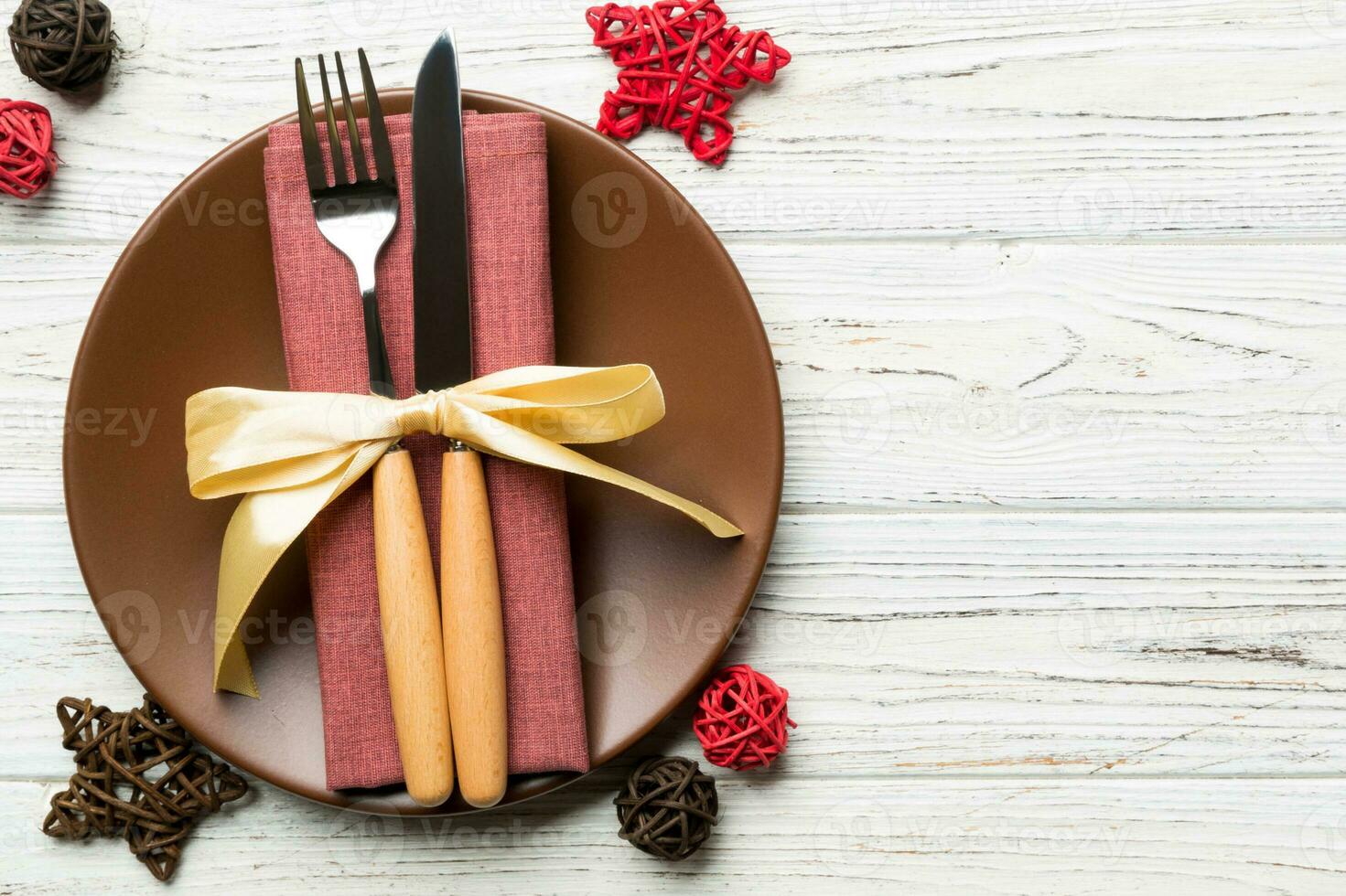 Holiday composition of Christmas dinner on wooden background. Top view of plate, utensil and festive decorations. New Year Advent concept with copy space photo