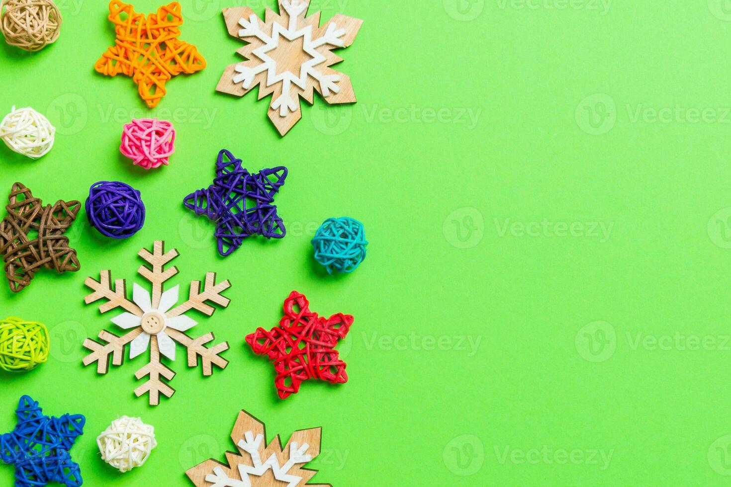 New Year decorations on green background. Festive stars and balls. Merry Christmas concept with empty space for your design photo