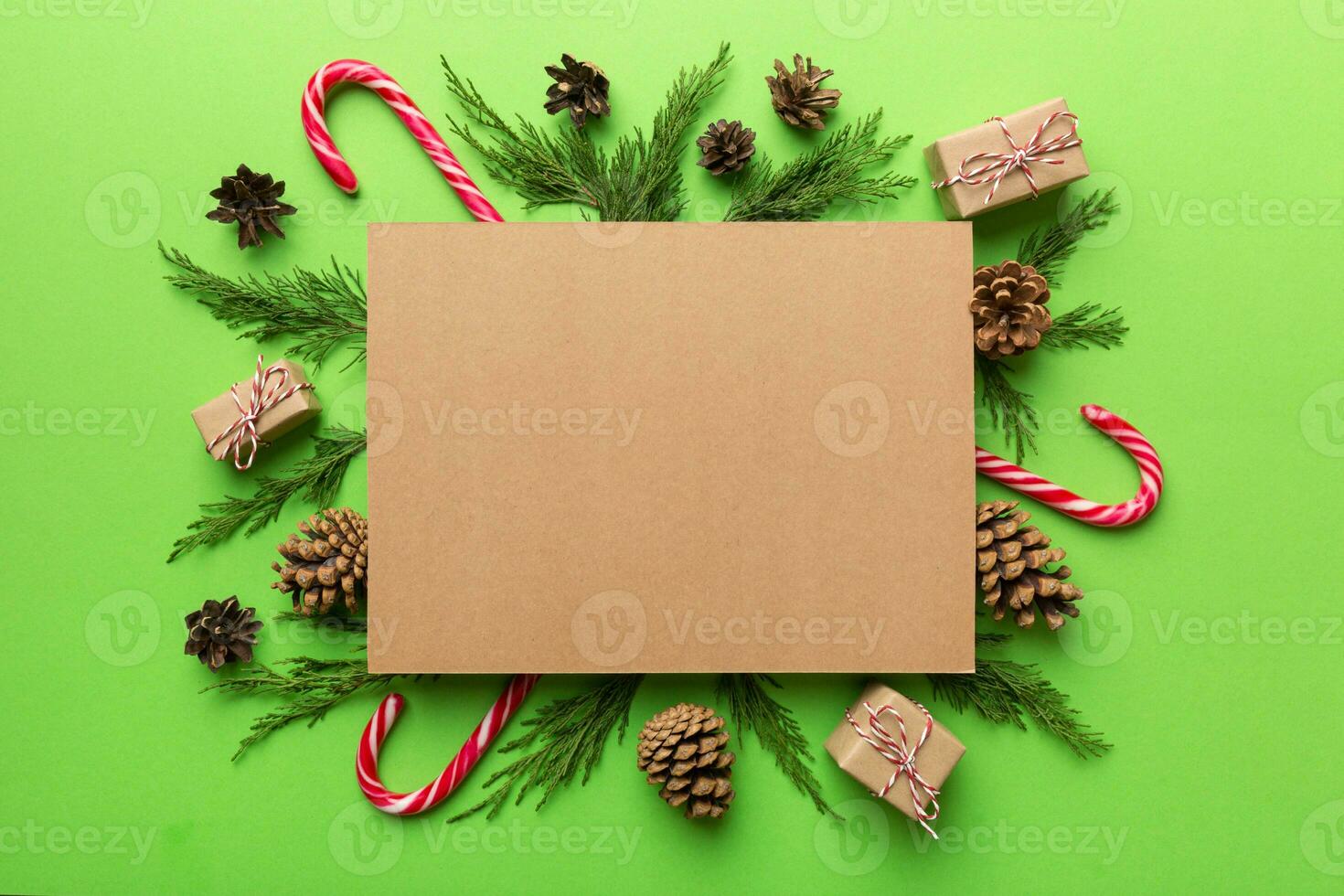 Flat lay Christmas composition. square Paper blank, pine tree branches, christmas decorations on Colored background. Top view, copy space for text photo